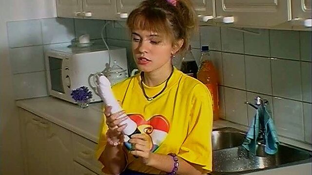 Thrifty blondie switches from washing dishes to polishing her twat with a dildo