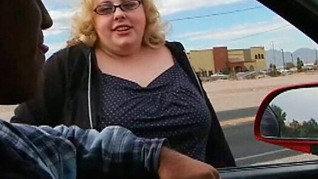 Blonde BBW wench with pale skin is giving a head in front of the camera