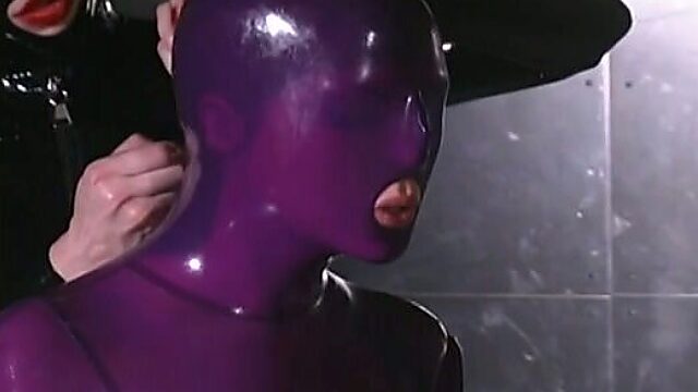 Submissive tied up chick in latex stuff gets slapped by horny domme