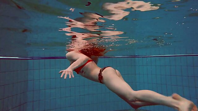 Sweet looking swimmer Katrin Bulbul is striping under the water